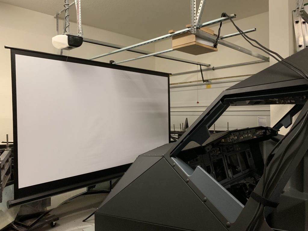 Projection screens increase the size of the outside view making it feel more realistic.
